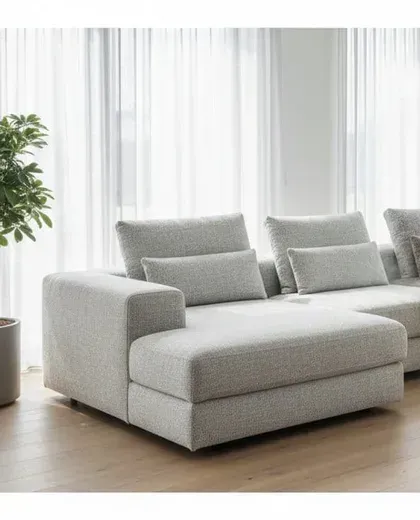 A bright lounge with a clean grey sofa